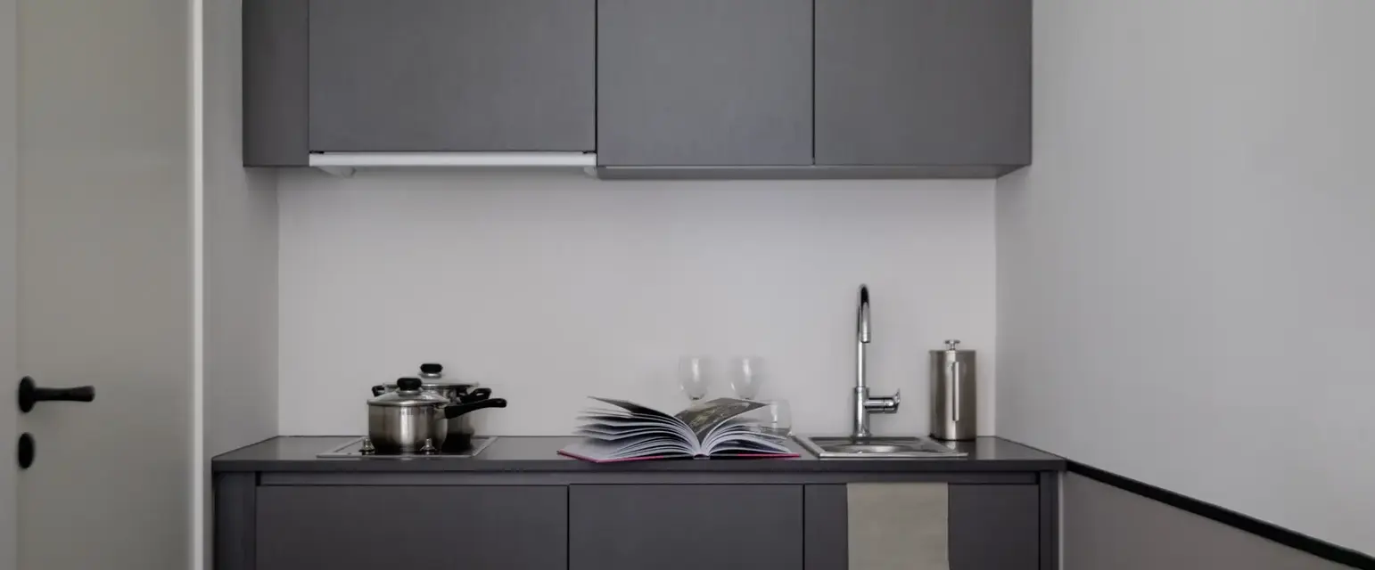 a kitchen with a book and a sink