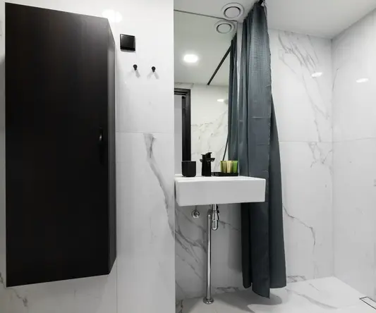 a bathroom with a sink and shower curtain