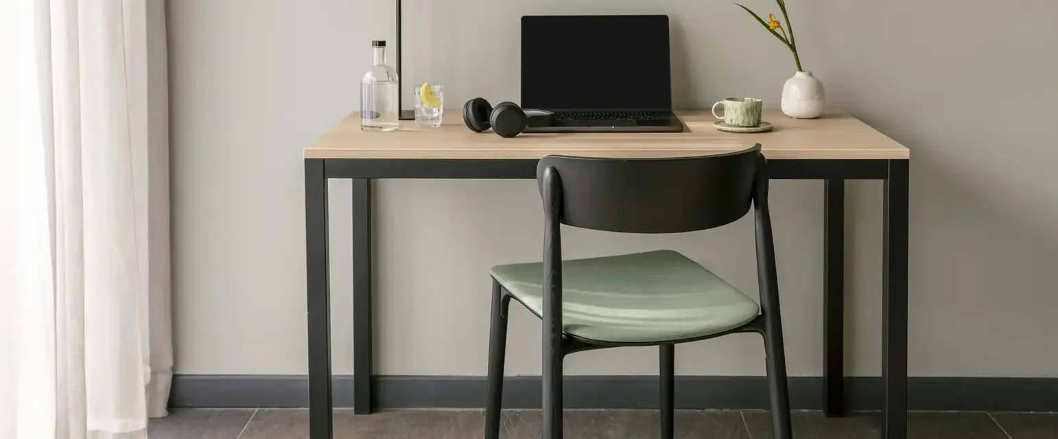 a desk with a laptop and a chair