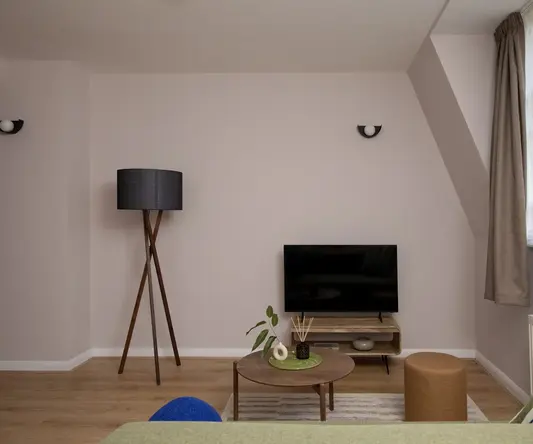 a room with a television and a lamp