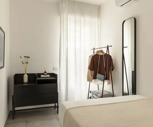 a room with a bed and a mirror