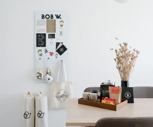 a table with a white board and a tray of coffee and bags