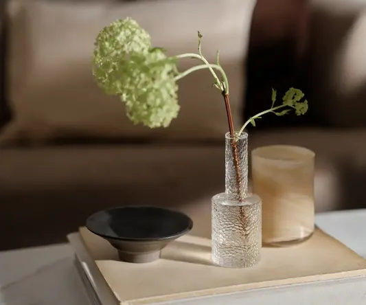 a vase with green leaves in it