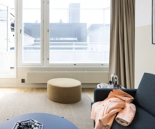 a room with a round table and a round ottoman