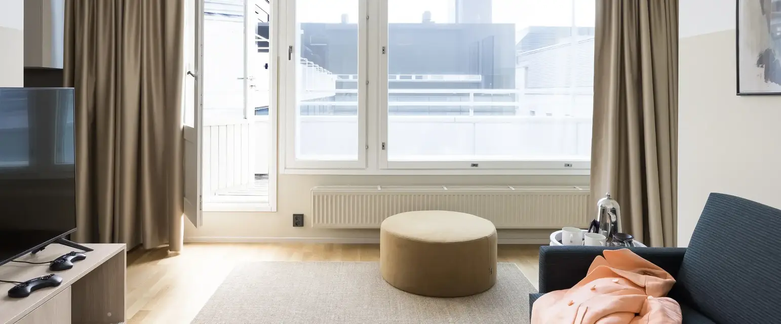 a room with a round table and a round ottoman