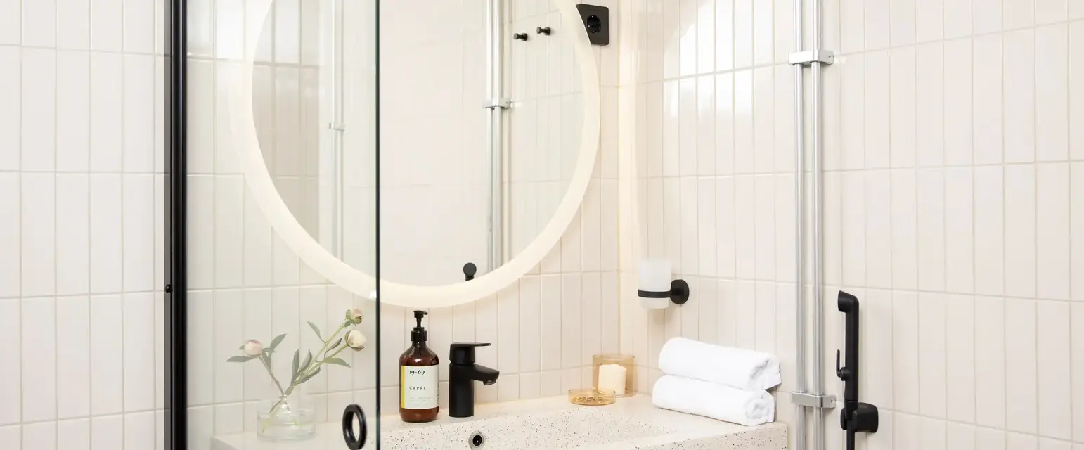 a bathroom with a round mirror
