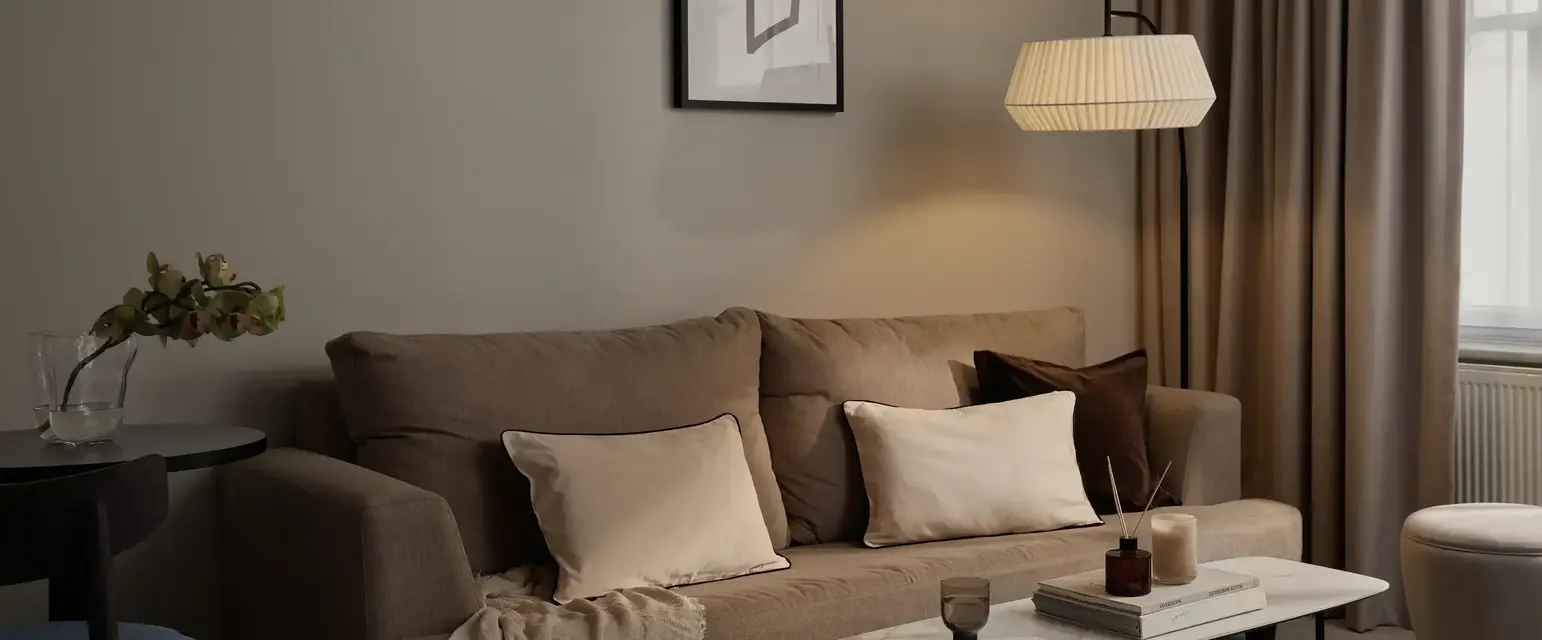 a living room with a couch and a lamp