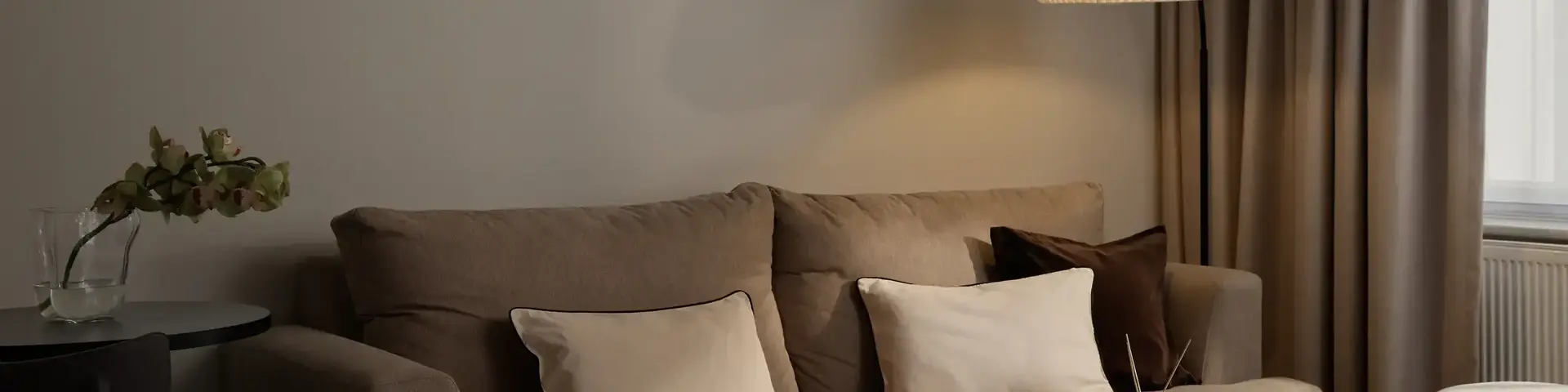 a living room with a couch and a lamp