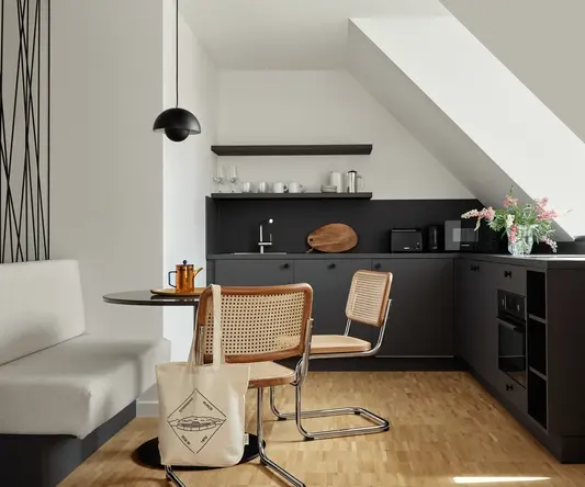 a kitchen with a table and chairs