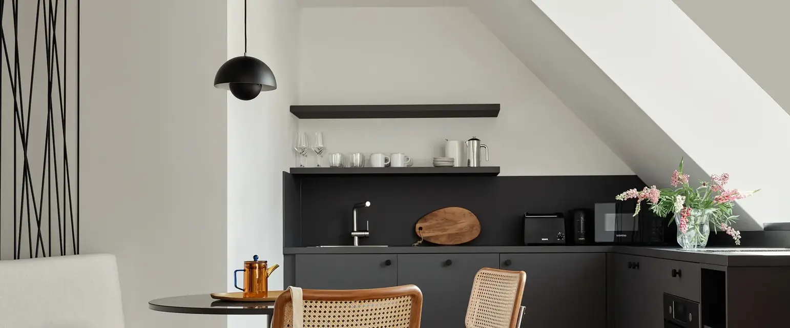 a kitchen with a table and chairs