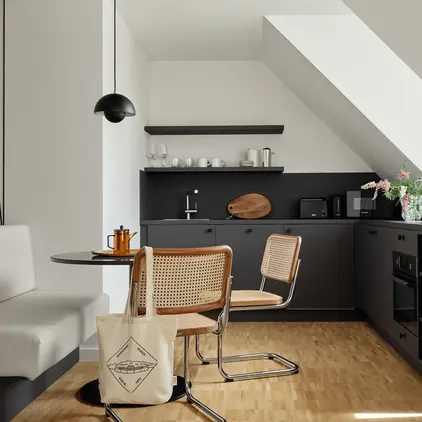 a kitchen with a table and chairs