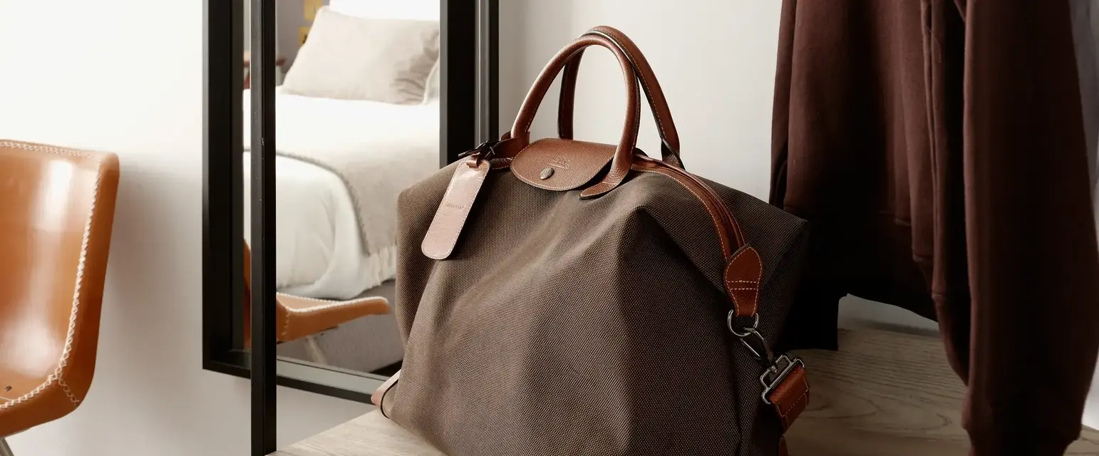 a bag and a coat on a rack