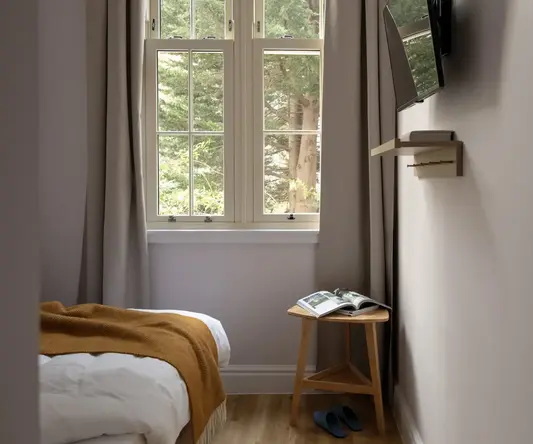 a bedroom with a mirror and a bed