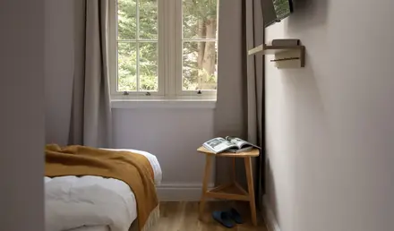a bedroom with a mirror and a bed