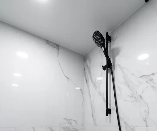 a shower with a hose and a shower head