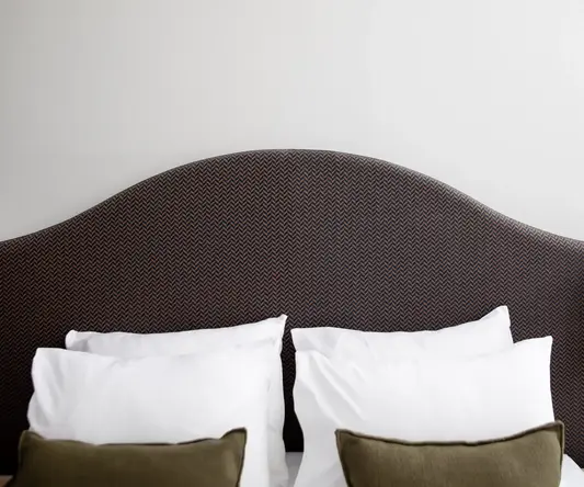a bed with pillows and a headboard