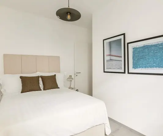 a bed with pillows in a room