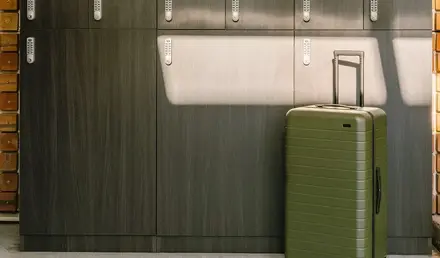 a suitcase in front of lockers