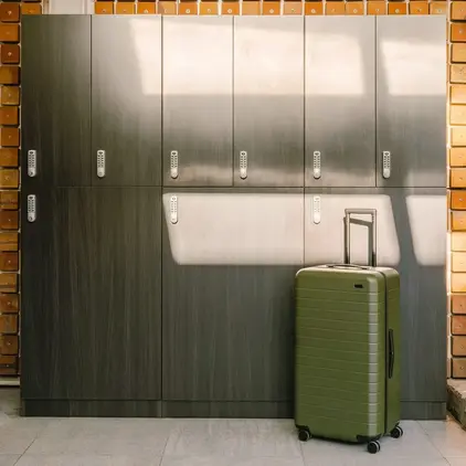 a suitcase in front of lockers