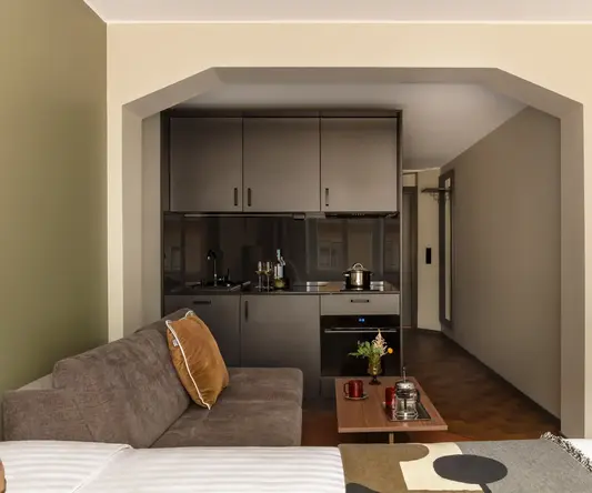 a living room with a couch and kitchen