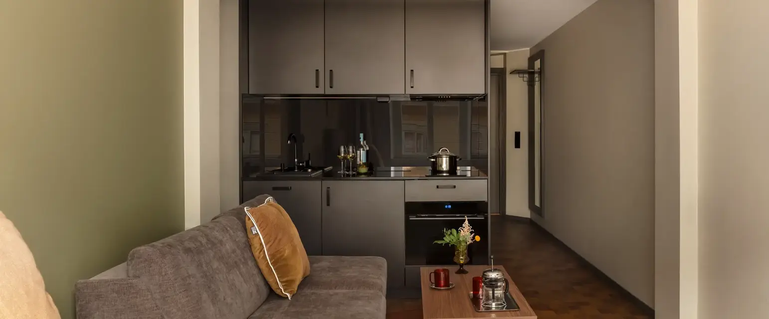 a living room with a couch and kitchen