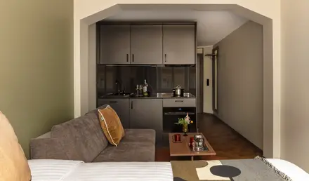 a living room with a couch and kitchen