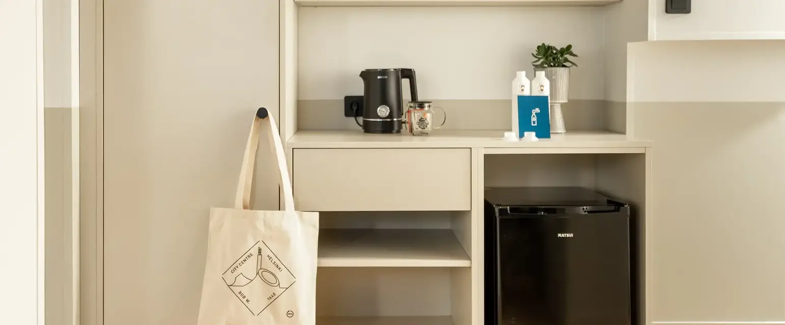a white shelf with shelves and a coffee maker