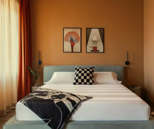 a bed with a black and white blanket and a black and white pillow