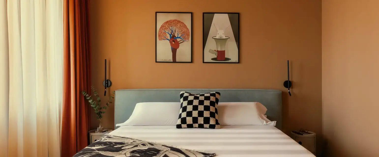 a bed with a black and white blanket and a black and white pillow