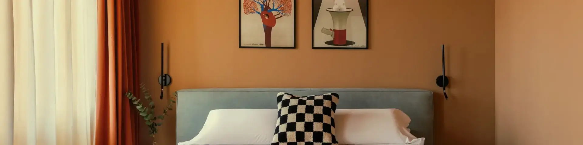 a bed with a black and white blanket and a black and white pillow