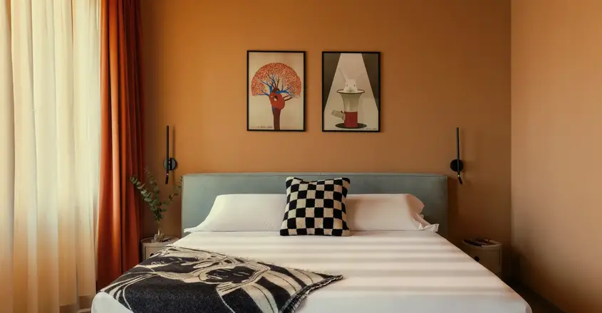 a bed with a black and white blanket and a black and white pillow