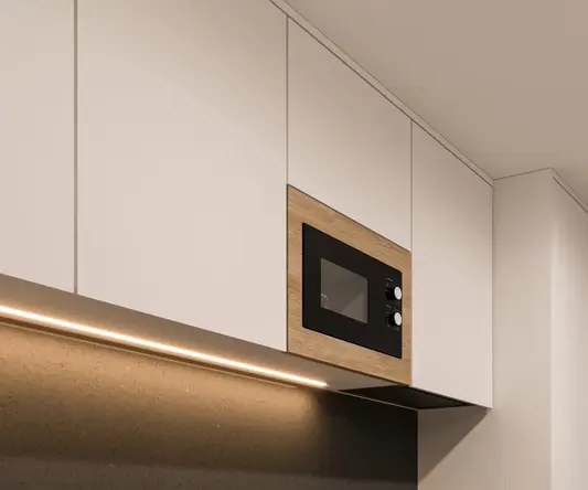 a kitchen with white cabinets and black countertops