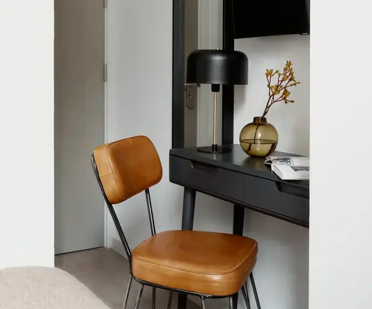 a chair next to a desk