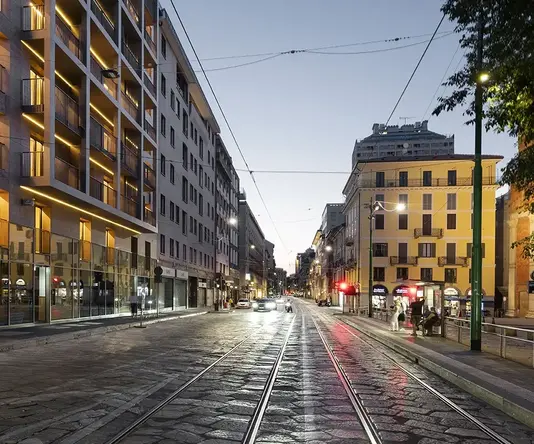 a street with buildings and a train track