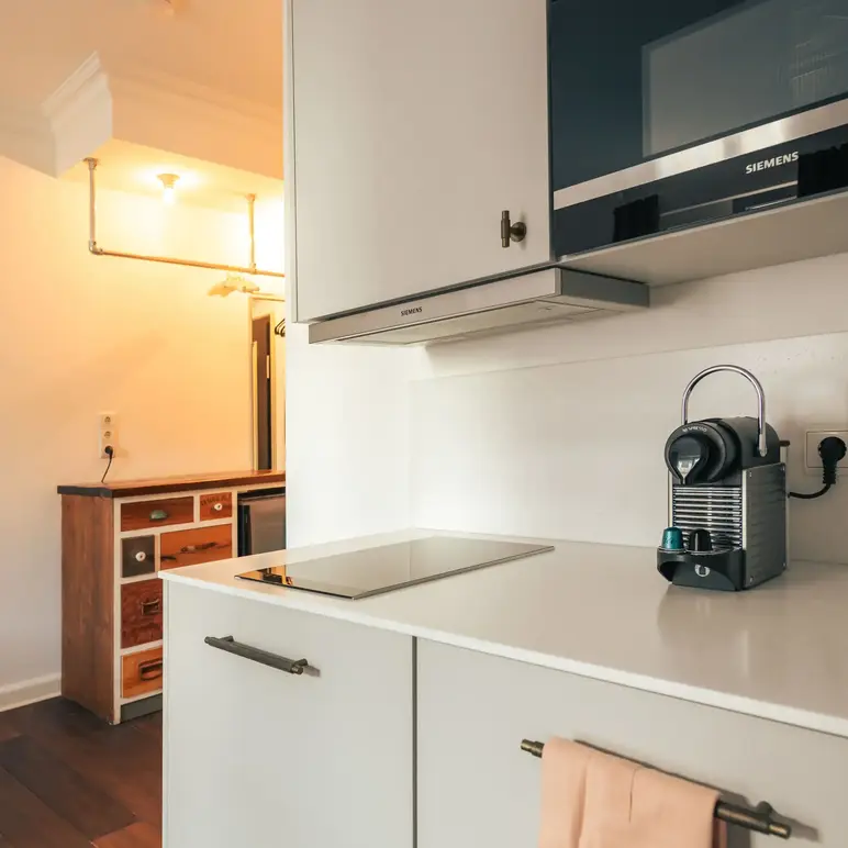 a kitchen with a microwave oven and a towel