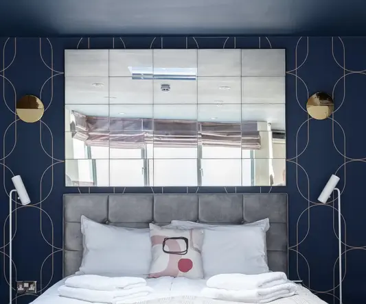 a bed with pillows and blankets on it