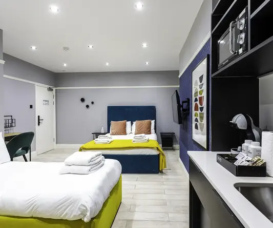 a room with two beds and a mirror