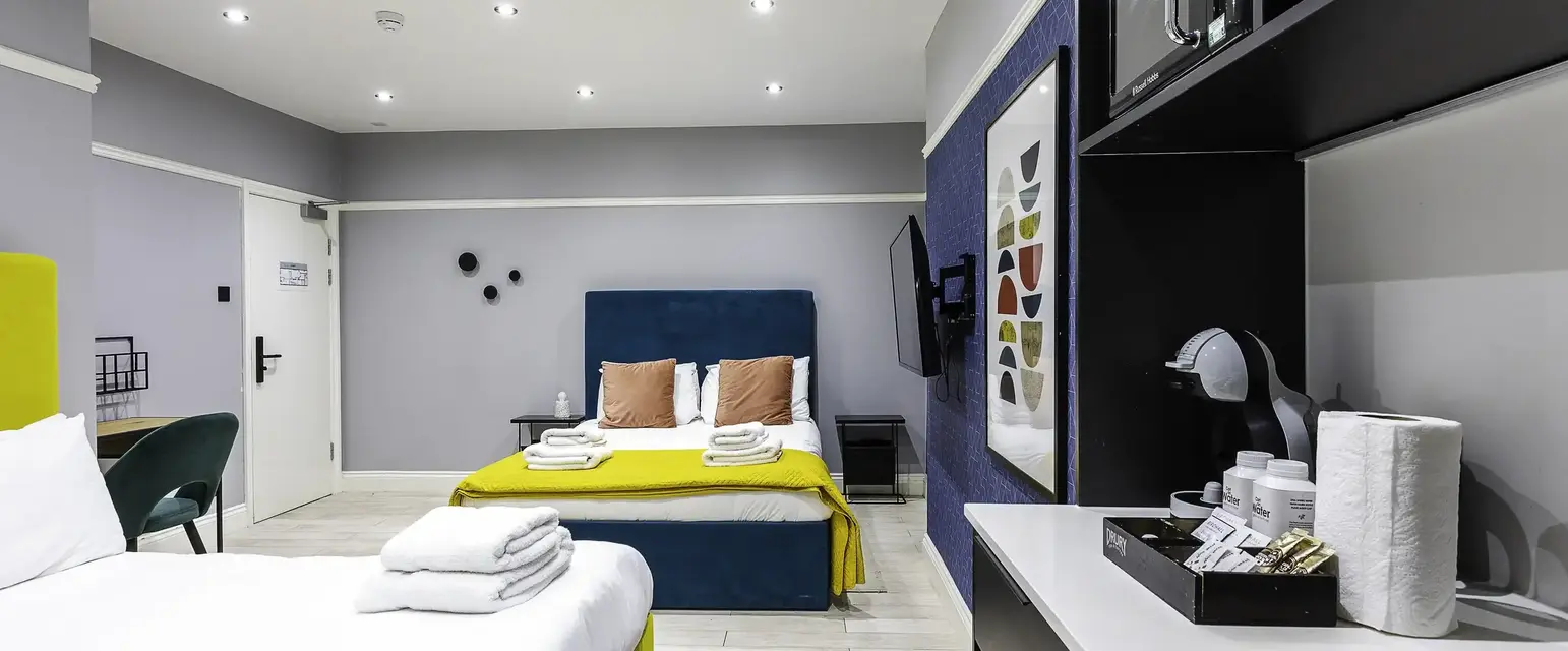 a room with two beds and a mirror