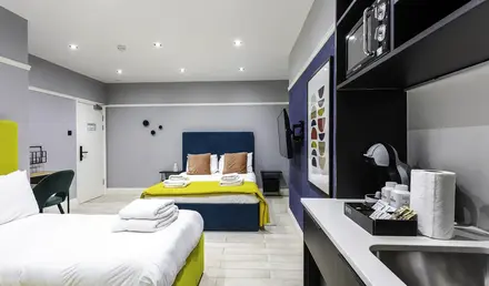 a room with two beds and a mirror