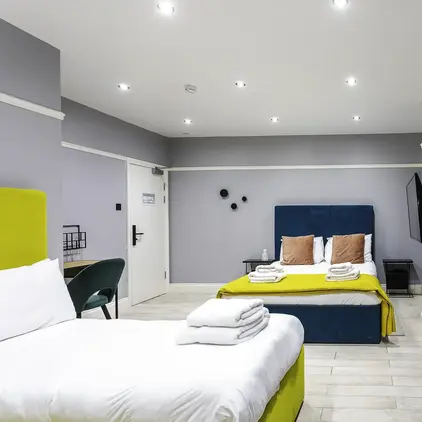 a room with two beds and a mirror