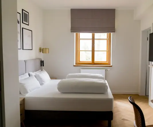 a room with a bed and a tv