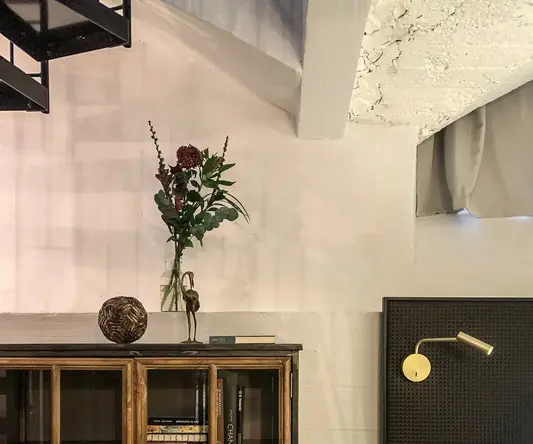 a room with a bed and a glass cabinet