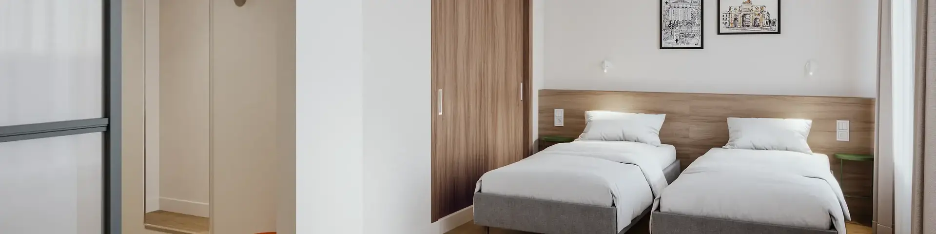 a room with two beds and a door