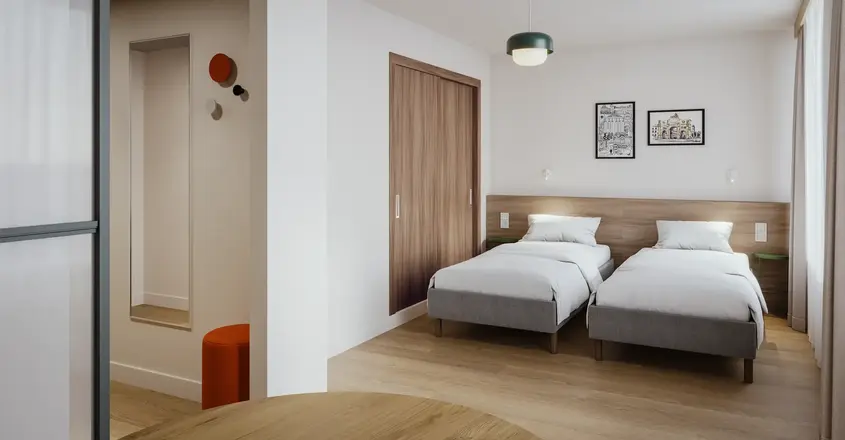 a room with two beds and a door