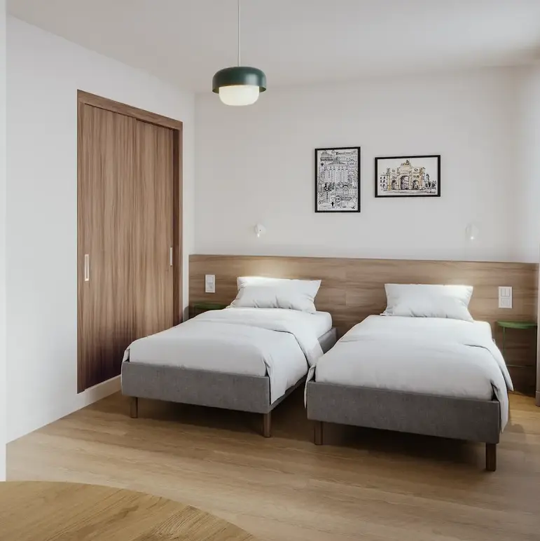 a room with two beds and a door