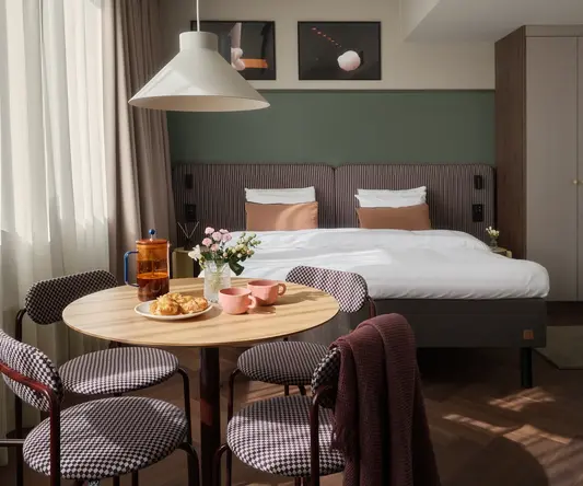 a room with a bed and a table with food and a chair