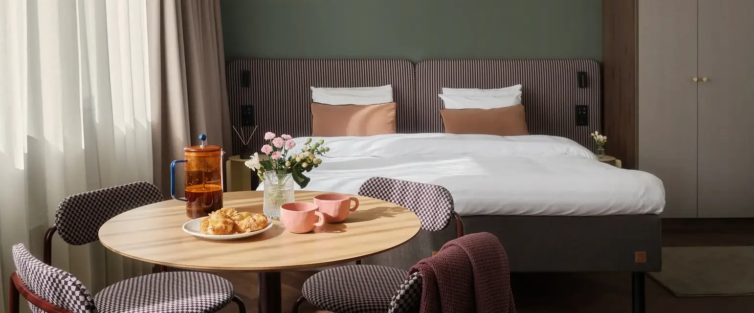a room with a bed and a table with food and a chair