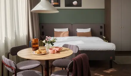 a room with a bed and a table with food and a chair
