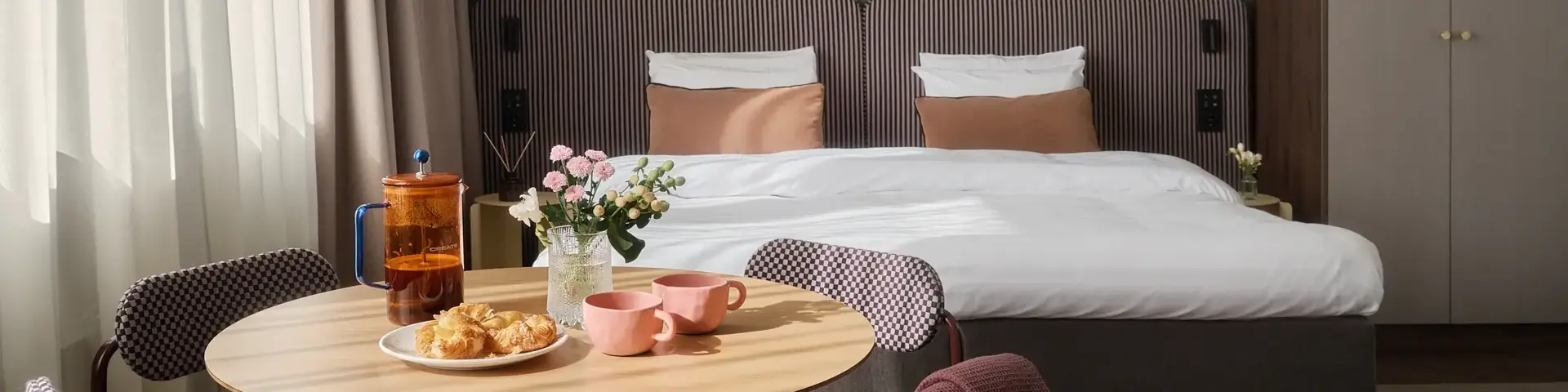 a room with a bed and a table with food and a chair
