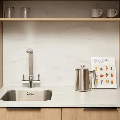 a sink and a book on a shelf